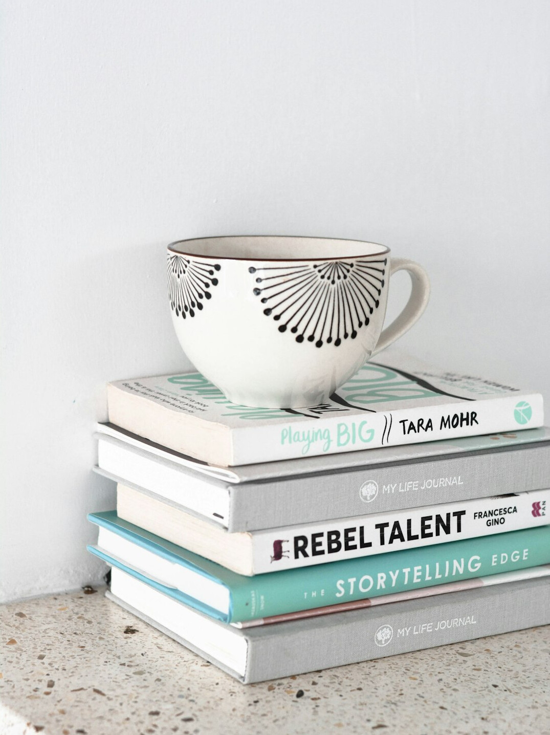 Bright workspace with books, albums and a notebook