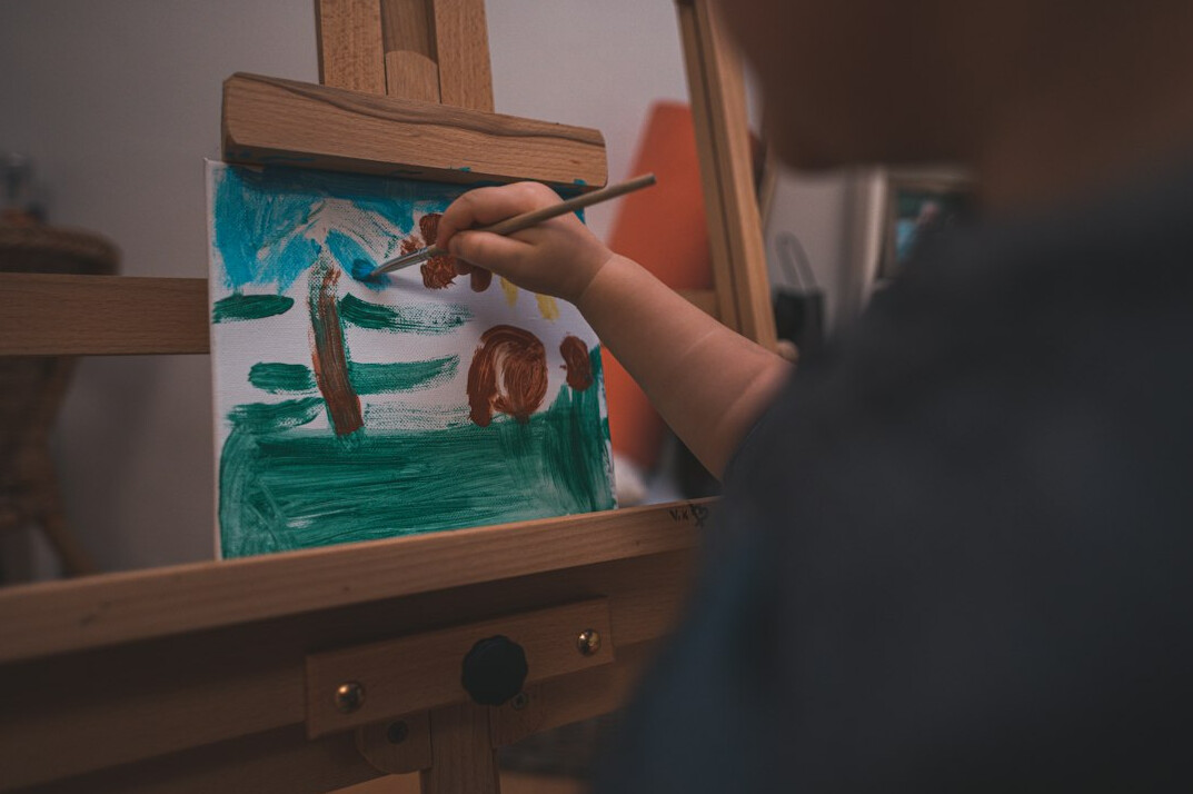 person painting traditional landscape